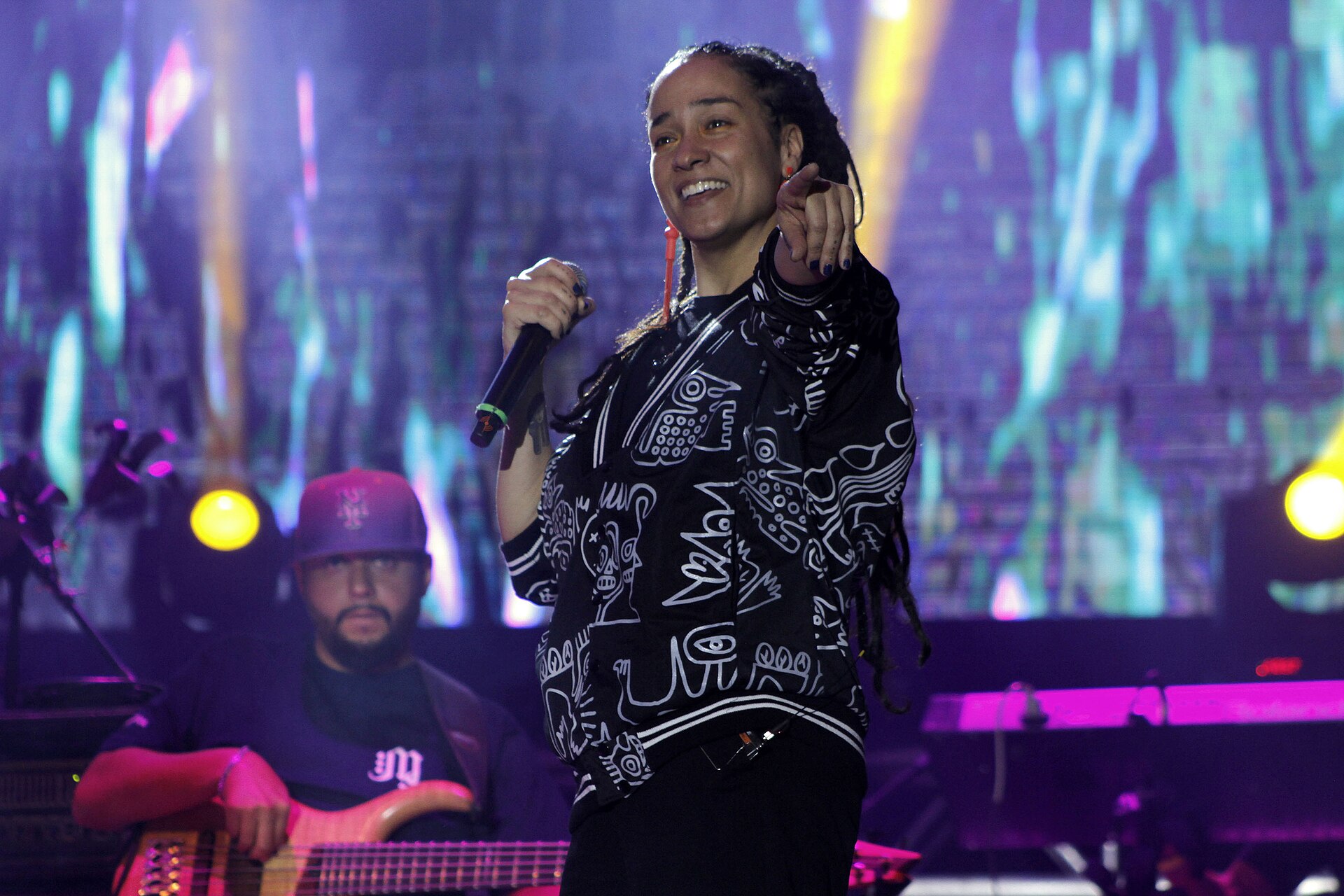 Alika cantando en un escenario, con micrófono
